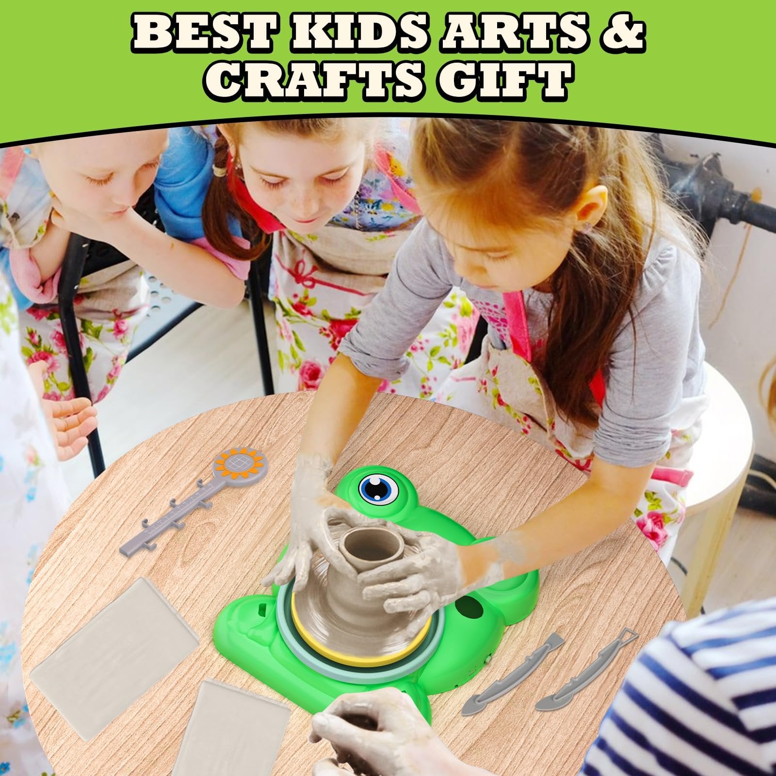 Children using a green frog-shaped pottery wheel with clay and tools on a wooden table