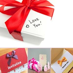 Stack of white boxes tied with a red satin ribbon and a handwritten 'Love You' note