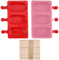 Two oval silicone popsicle molds, one red and one pink, with a stack of wooden sticks below.