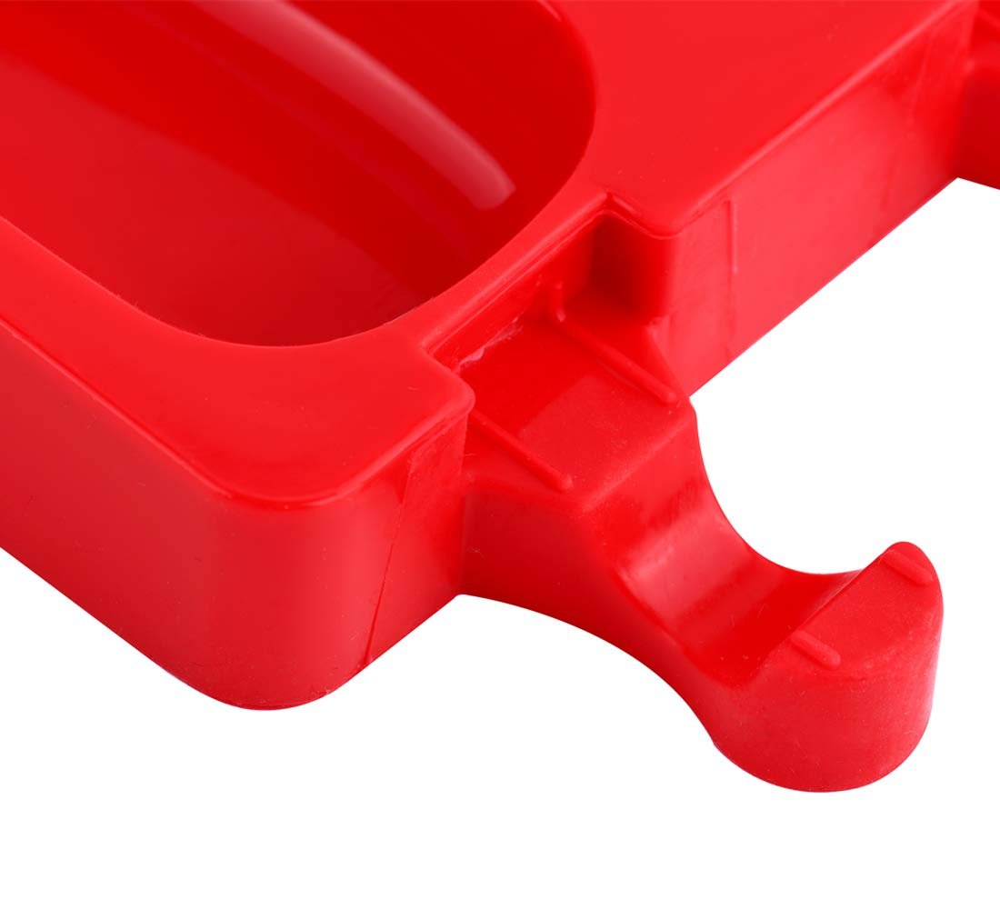 Close-up of a red silicone popsicle mold showing the oval cavities and stick holders.
