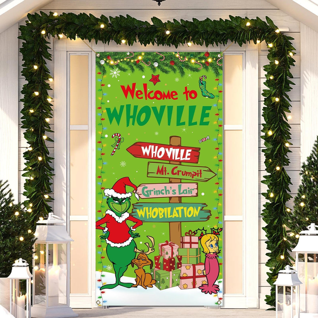 Christmas banner with Grinch characters and Whoville signs hanging on a door, decorated with garlands.