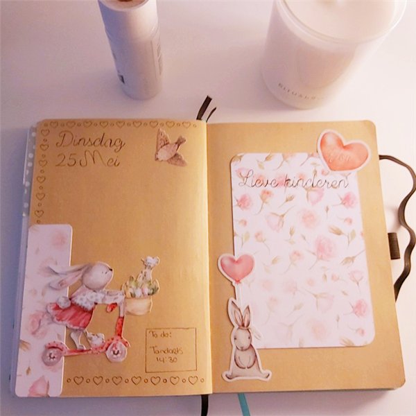 Open journal page with bunny stickers, floral designs, and handwritten Dutch text for a planner layout.