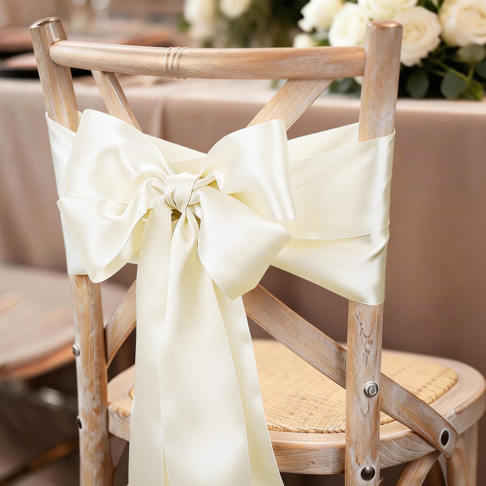 Ivory double faced satin ribbon tied in a large bow around a wooden chair back