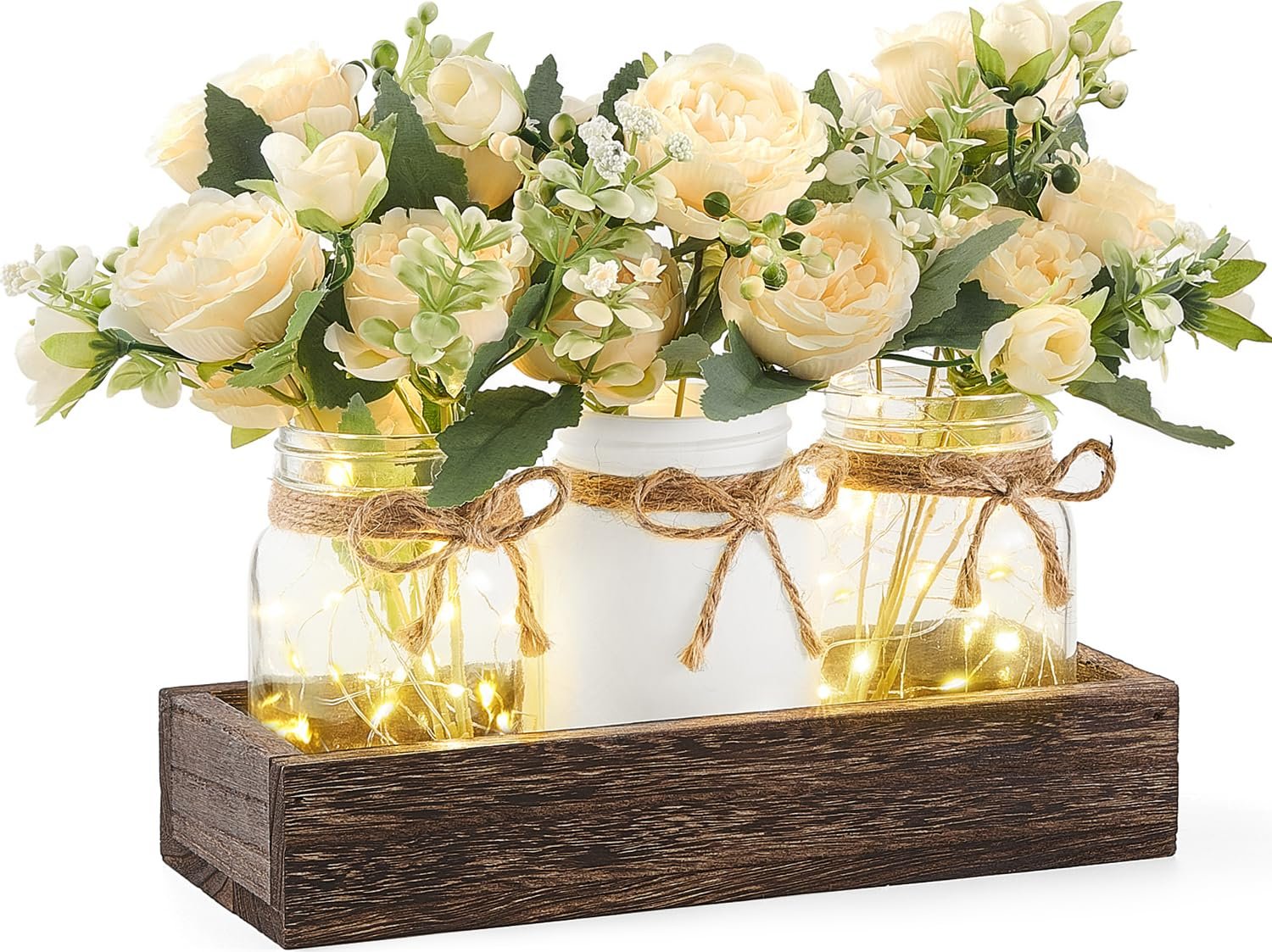 Three mason jars with artificial flowers and string lights in a wooden tray, farmhouse decor
