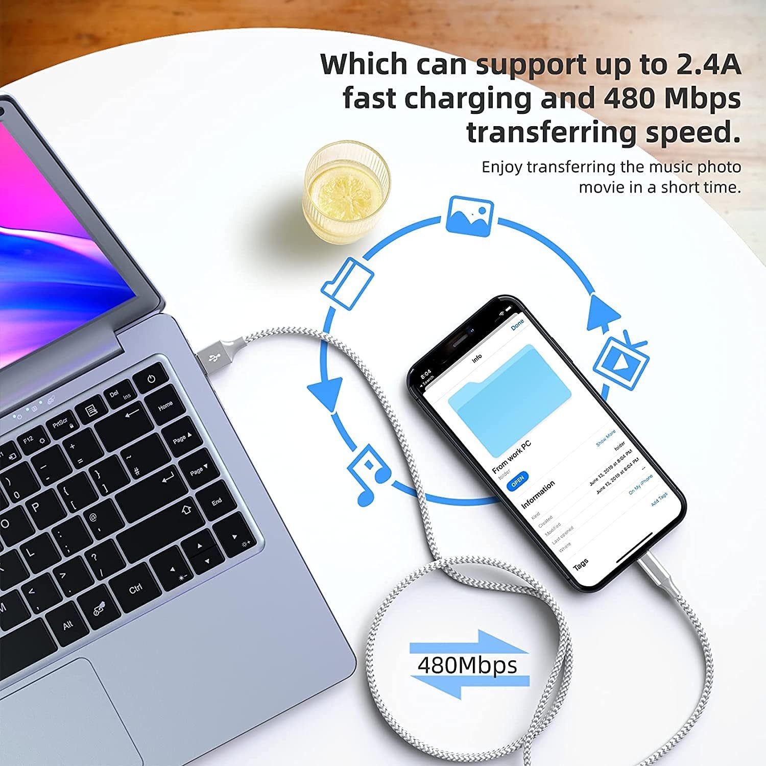 Grey and white braided USB-C cable connecting a laptop and a smartphone, illustrating fast charging and data transfer speeds.