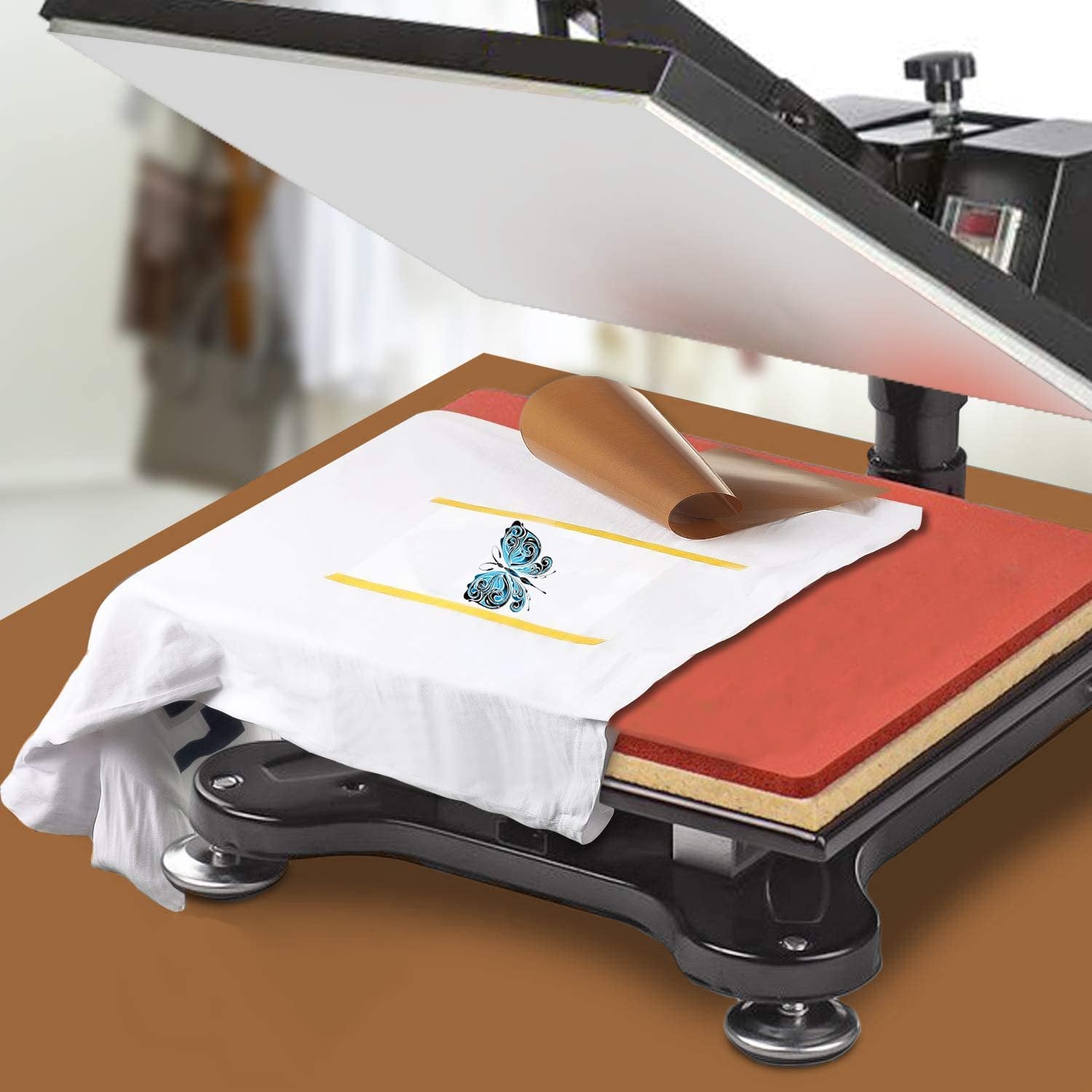 Heat press machine with a white t-shirt and PTFE heat press sheet on the platen, preparing for sublimation.