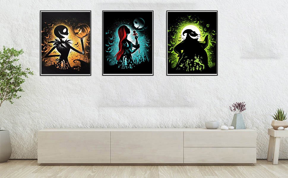 Three framed Halloween-themed diamond art paintings displayed on a wall above a credenza.