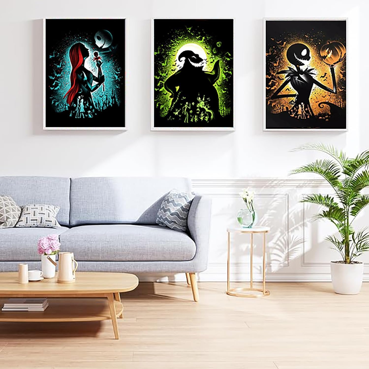 Three framed Halloween-themed diamond art paintings hanging on a wall above a sofa.