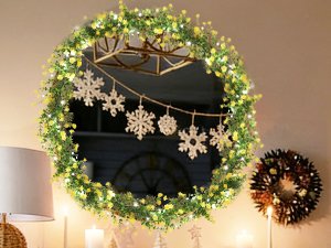 Artificial eucalyptus garland with LED lights and snowflakes draped on a mirror