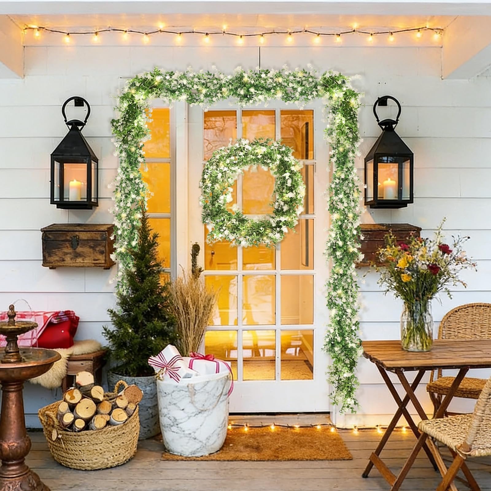 Artificial eucalyptus garland and wreath with LED lights decorating a doorway and porch