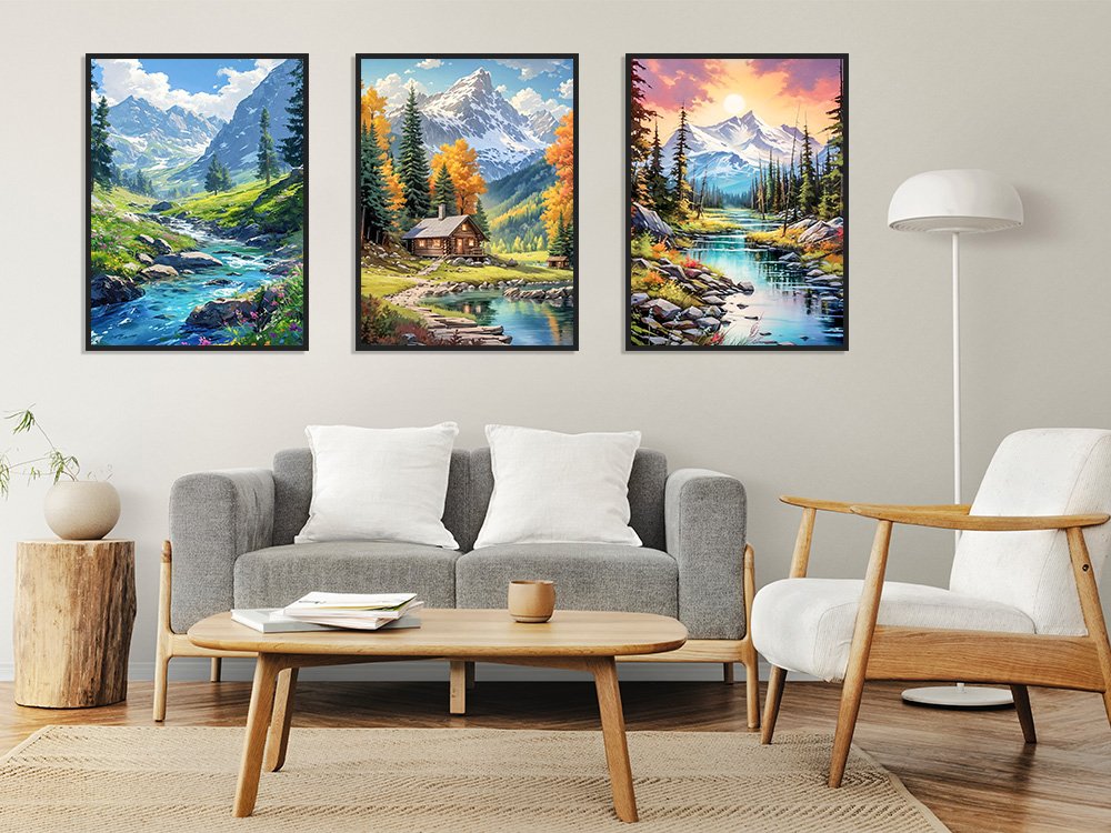 Three framed landscape diamond paintings depicting mountain streams and cabins displayed on a wall above a sofa.