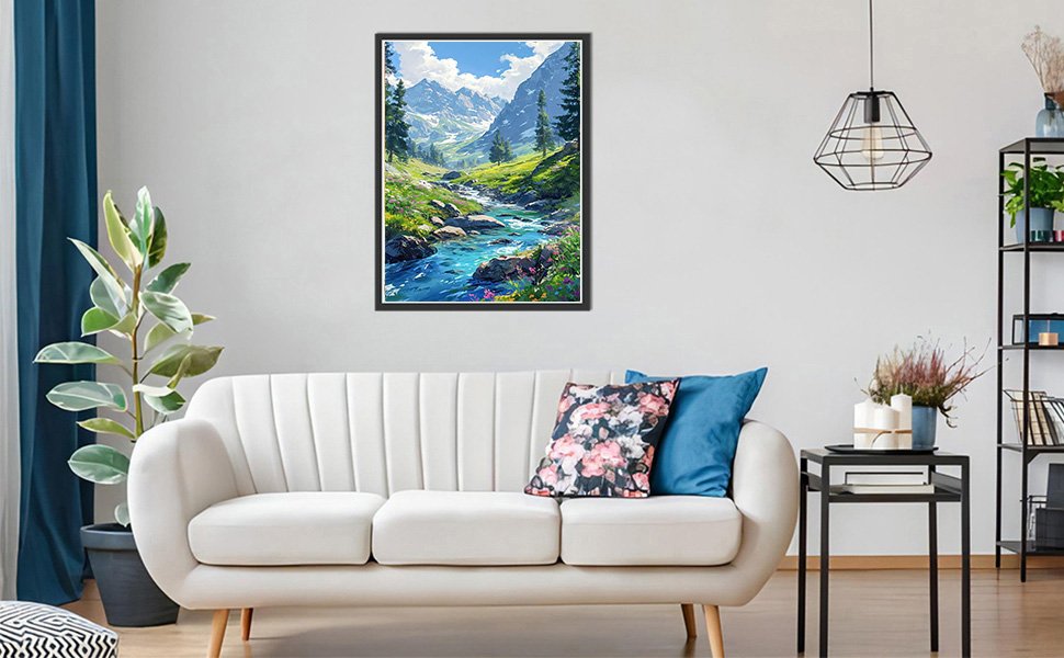 Diamond painting kit of a mountain stream landscape hanging on a wall above a sofa.