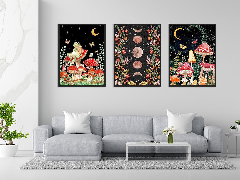 Three framed diamond painting kits depicting whimsical mushroom and celestial scenes hanging on a wall above a sofa.