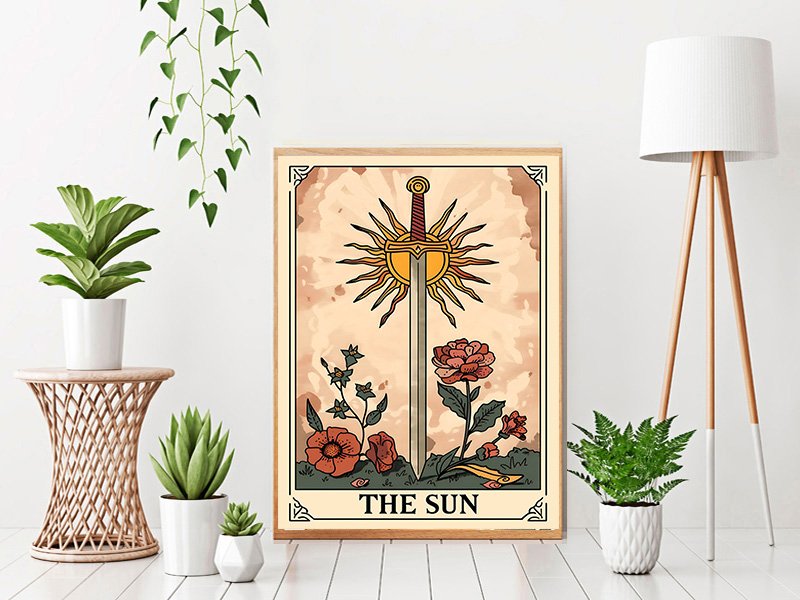Framed tarot card art print of 'The Sun' with sword and sun motif, surrounded by flowers and plants.