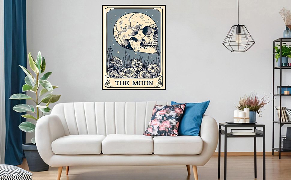 Tarot card art print of a skull and flowers with "The Moon" text, displayed above a sofa.
