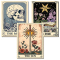 Three tarot card art prints featuring a skull and moon, a star and book, and a sword with sun and flowers.