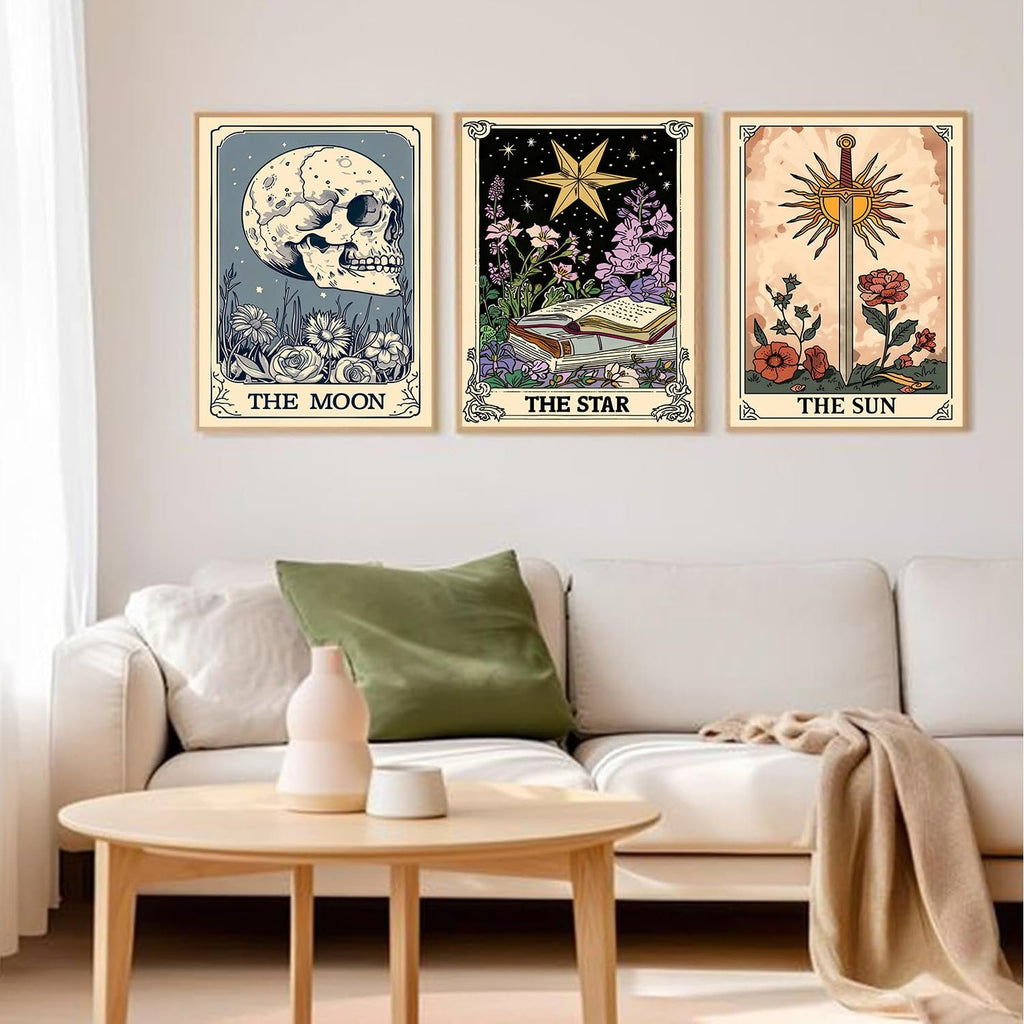 Three framed tarot-themed diamond art paintings hanging on a wall above a sofa: The Moon with a skull, The Star with books, and The Sun with a sword.