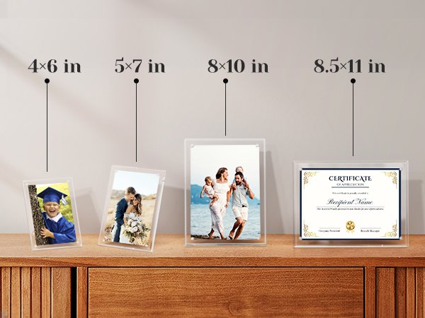 Four clear acrylic picture frames displaying photos and a certificate on a wooden surface.