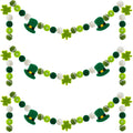 Three green and white felt pom pom garlands with shamrocks and leprechaun hats for St. Patrick's Day