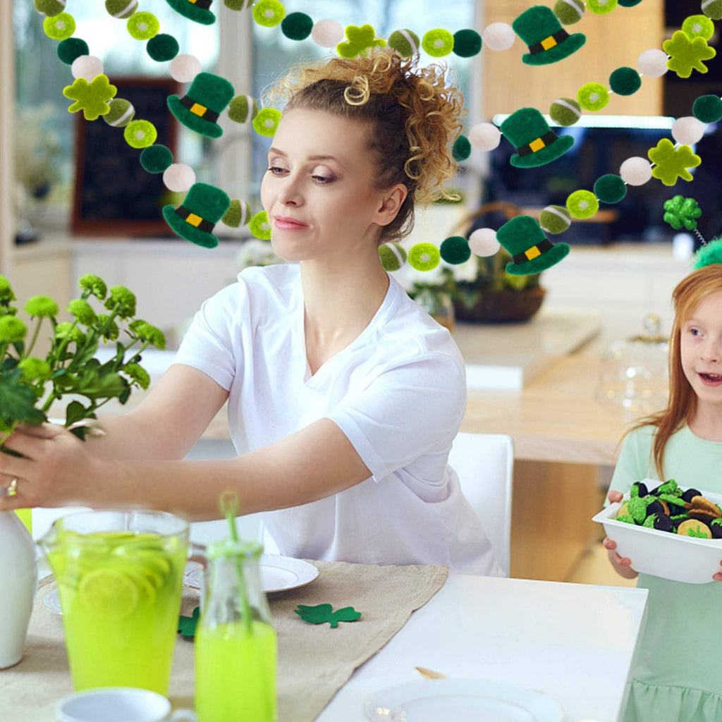 Woman and child at a table with St. Patrick's Day garland featuring shamrocks and leprechaun hats