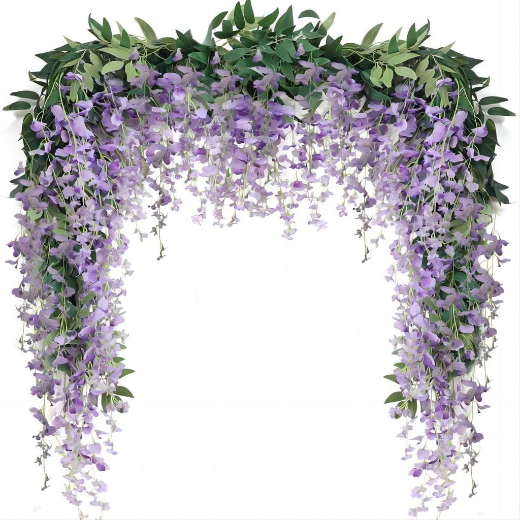 Artificial purple wisteria vine garland with green leaves draped over a white background