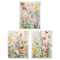 Three framed paint by numbers canvases featuring colorful wildflower arrangements on a cream background.
