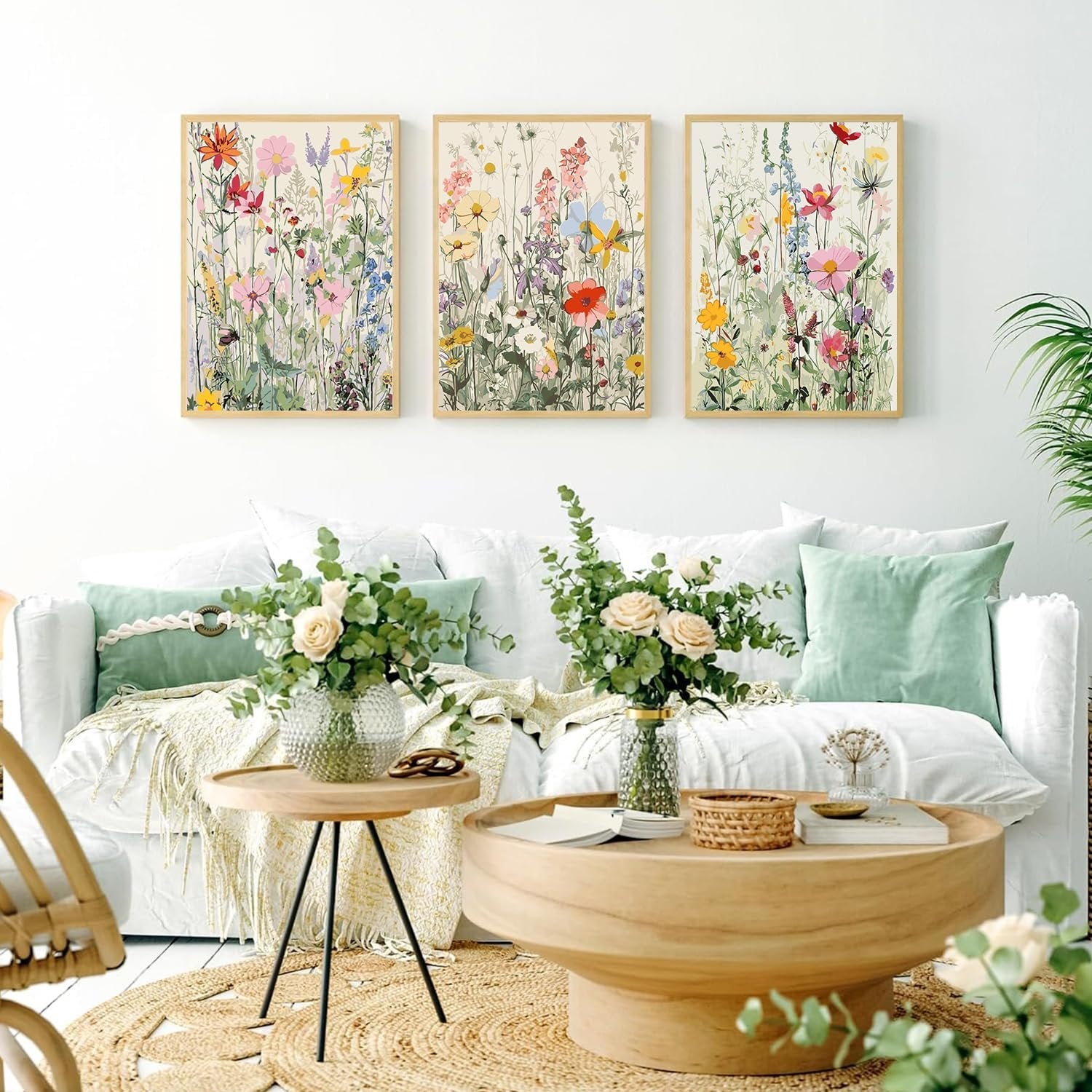 Three framed wildflower paint by numbers art pieces displayed on a white wall above a sofa.