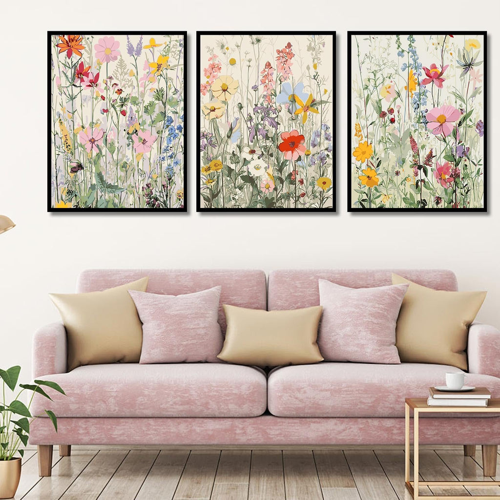 Three framed wildflower paint by numbers art pieces displayed above a pink sofa.