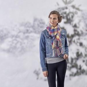 Woman wearing a denim jacket and scarf in a snowy outdoor setting
