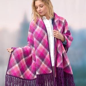 Woman wearing a pink and purple diamond pattern knitted shawl with fringe