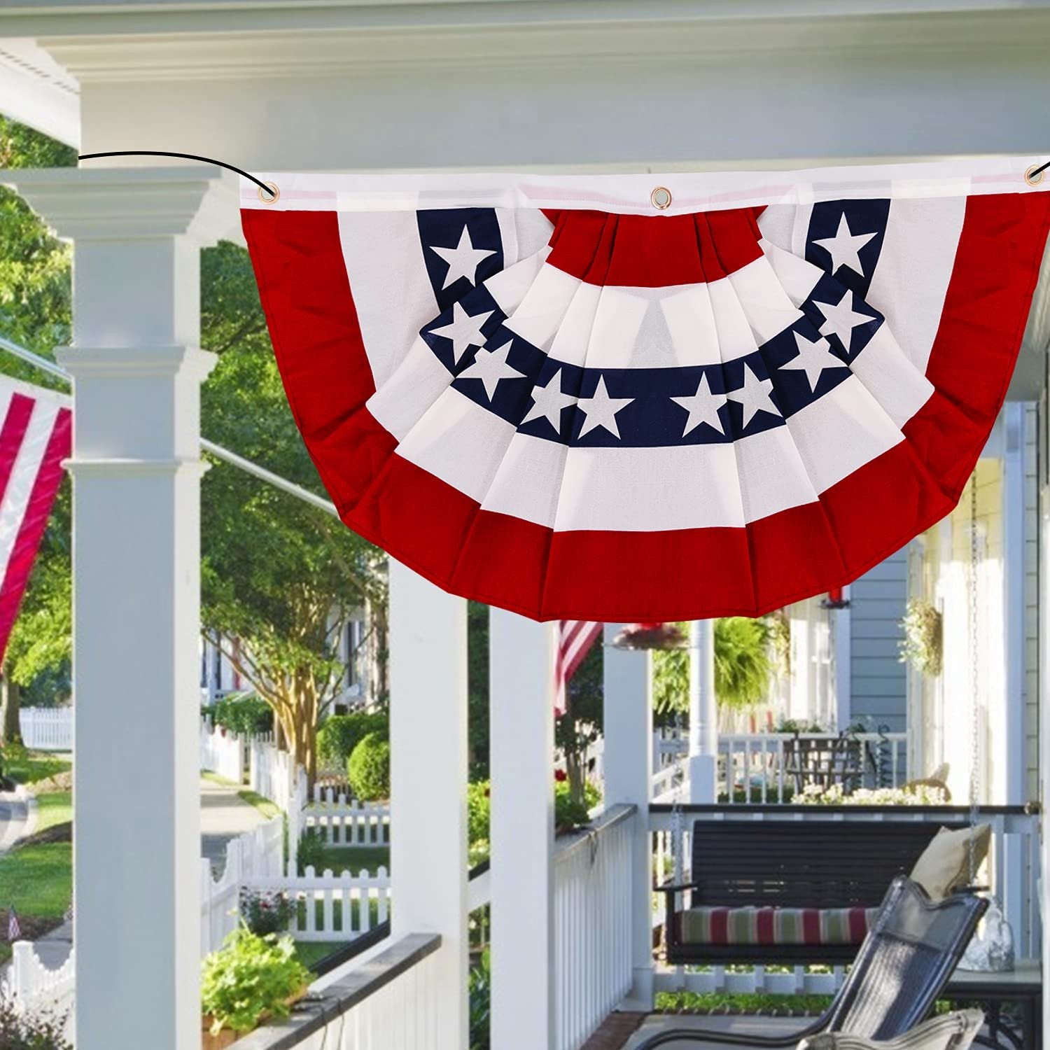 American pleated fan flag bunting with red, white, and blue stripes and stars, hanging on a porch.