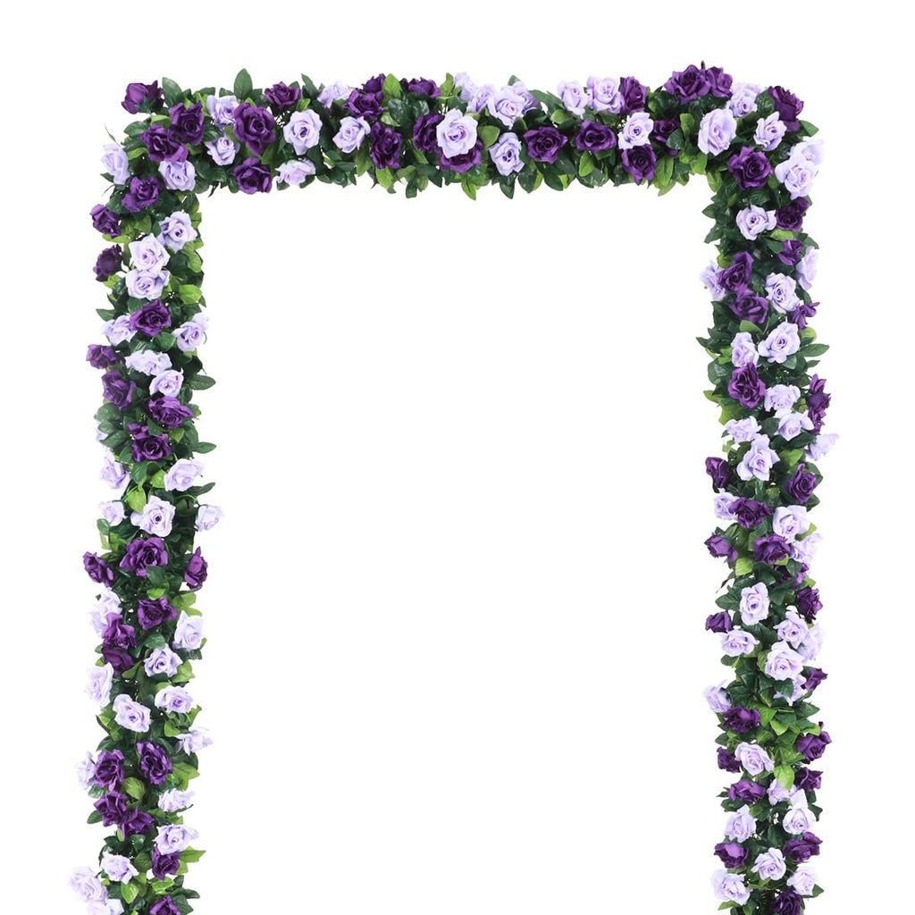 Artificial purple and lavender rose flower garland draped in an arch shape against a white background.