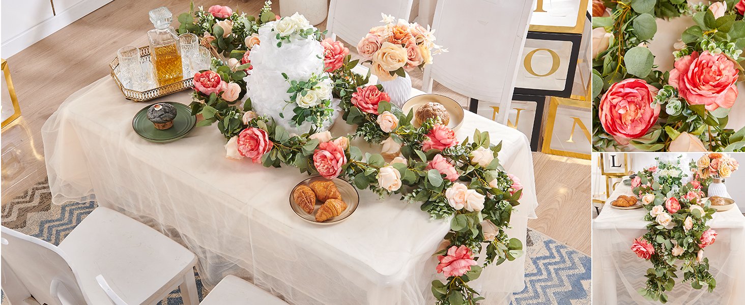 Artificial rose vine garland draped over a table with a cake, pastries, and drinks for a celebration.