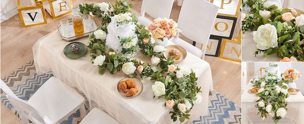 Table setting with artificial rose garlands, cake, pastries, and decorative letter blocks.