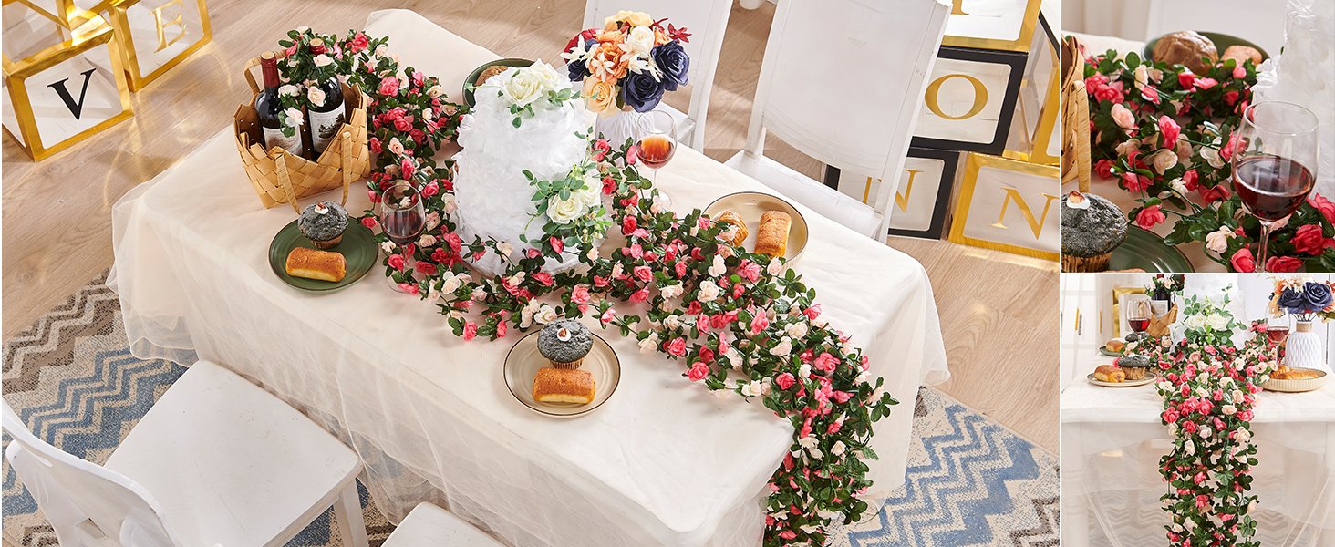 Table setting with artificial rose garlands, cupcakes, wine, and decorative blocks spelling 'LOVE'