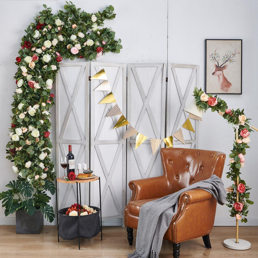 Artificial rose vine garland draped over furniture with a deer painting on the wall