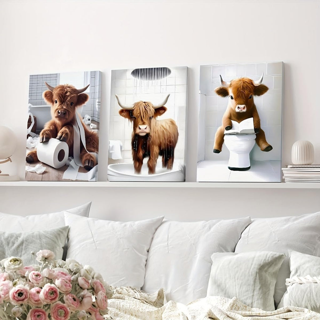 Three framed diamond art paintings of Highland cows in bathroom scenes: one with toilet paper, one showering, and one reading on a toilet.