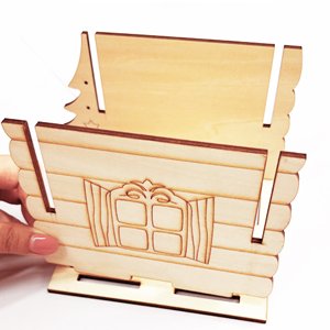 Wooden birdhouse craft kit unassembled, showing front panel with window detail and side panel with tree cutout.