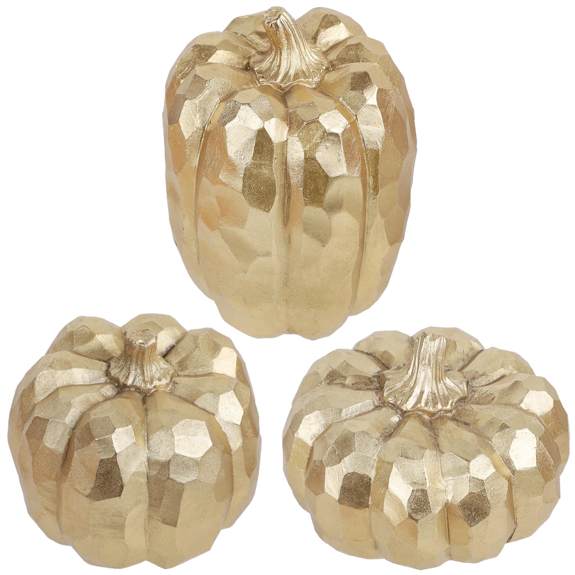 Three gold faceted resin pumpkins on a white background, arranged in a cluster.