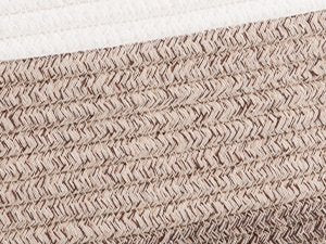 Close-up of woven cotton rope storage basket texture with cream trim at the top.