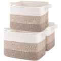 Three gradient yellow woven storage baskets with white handles stacked together on a white background.