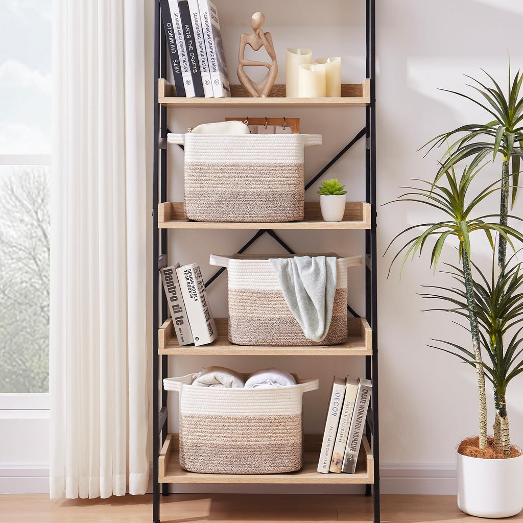 Three woven storage baskets with gradient yellow and white stripes on a bookshelf, one with a light blue blanket.