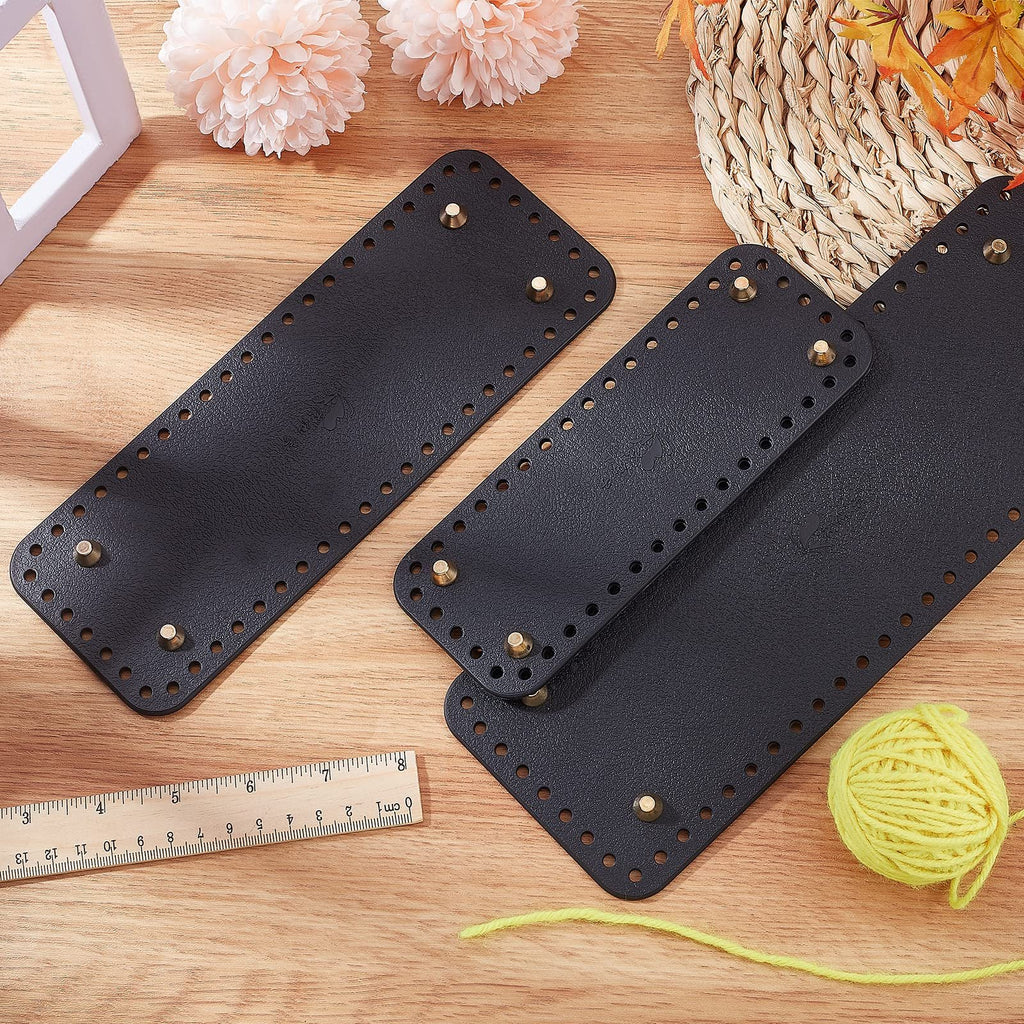 Three black rectangular leather purse bottoms with pre-punched holes and brass feet, arranged on a wooden surface with a ruler and yellow yarn.