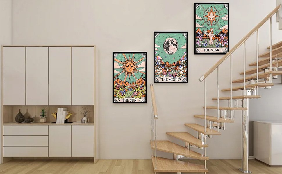Three framed tarot-themed diamond art paintings hanging on a wall next to a staircase and cabinet.