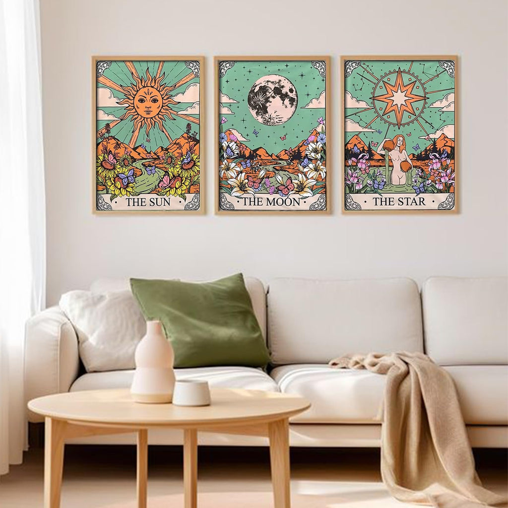 Three framed tarot-themed diamond art paintings of the Sun, Moon, and Star displayed on a wall above a sofa.