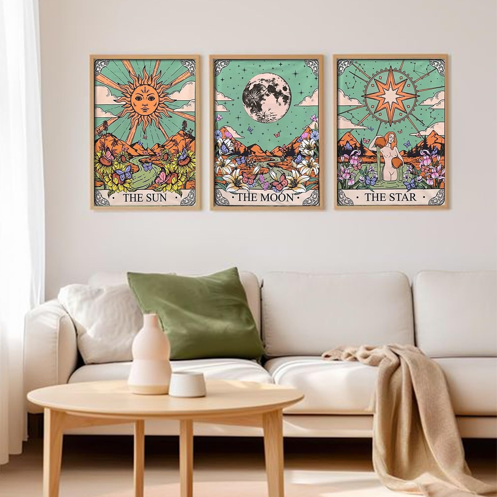 Three framed tarot-themed diamond art paintings of the Sun, Moon, and Star displayed on a wall above a sofa.