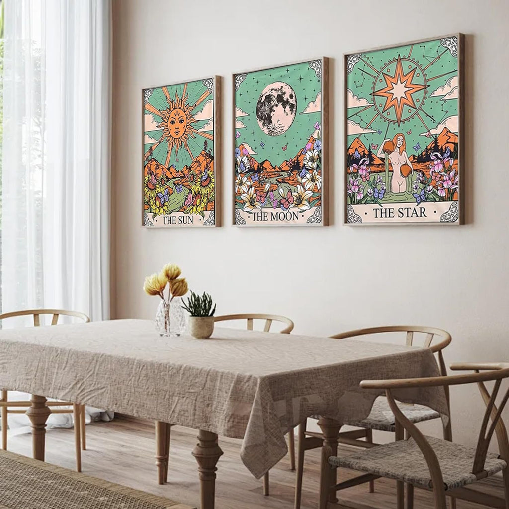 Three framed tarot-themed diamond art paintings of the Sun, Moon, and Star hanging on a wall above a dining table.