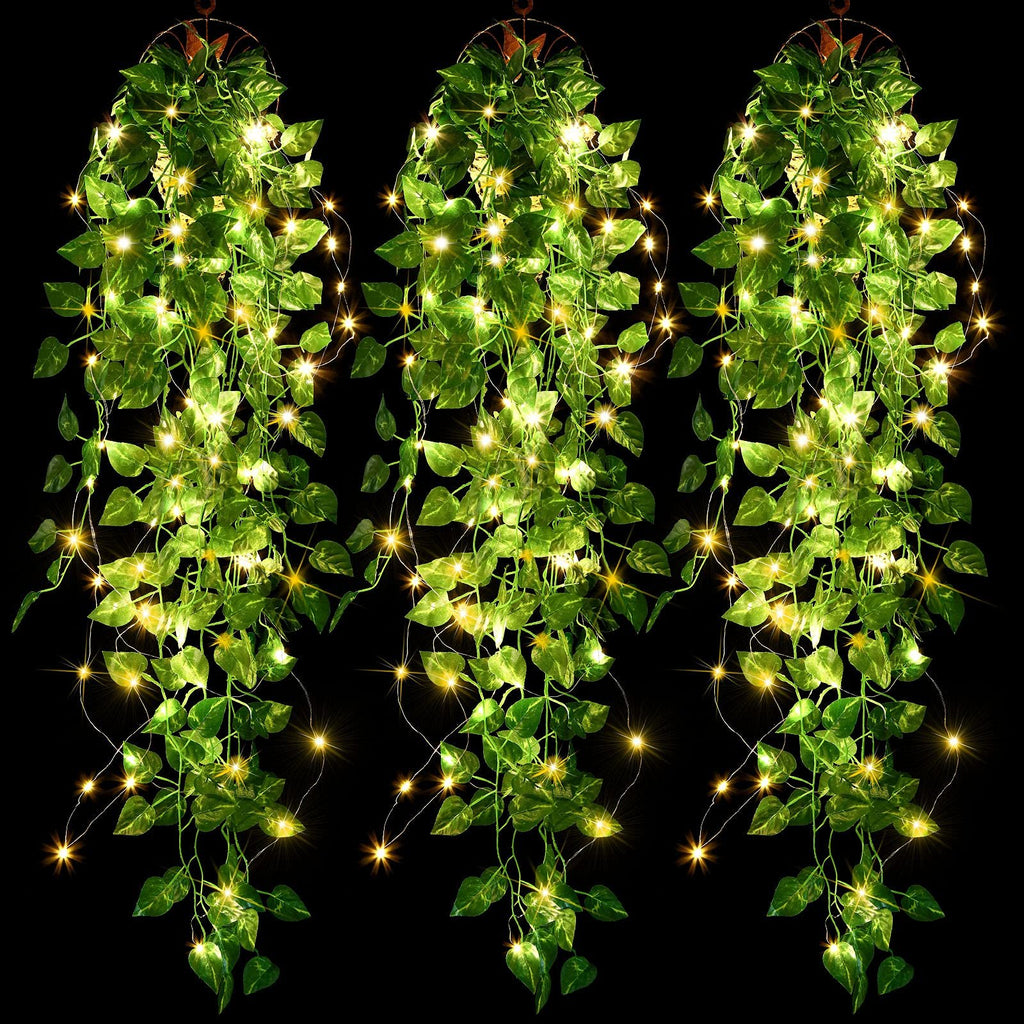 Three strands of artificial purple ivy vines with 90 warm white LED fairy lights, hanging against a black background.
