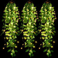 Three strands of artificial purple ivy vines with 90 warm white LED fairy lights, hanging against a black background.