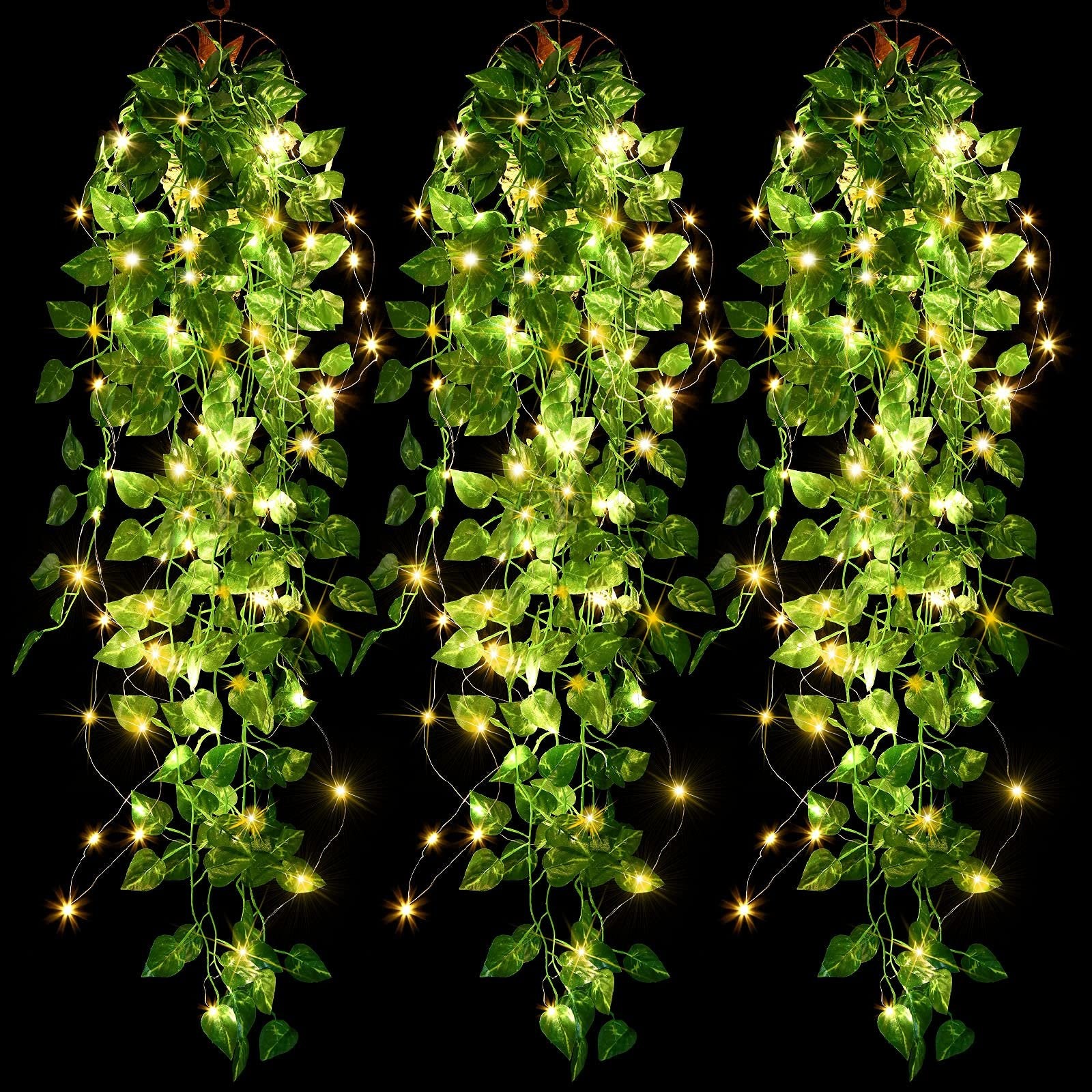 Three strands of artificial purple ivy vines with 90 warm white LED fairy lights, hanging against a black background.